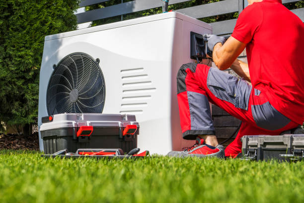 Backyard Swimming Pool Heat Pump Maintenance Performed by Caucasian HVAC Technician. Pool Heating Modern Technologies.